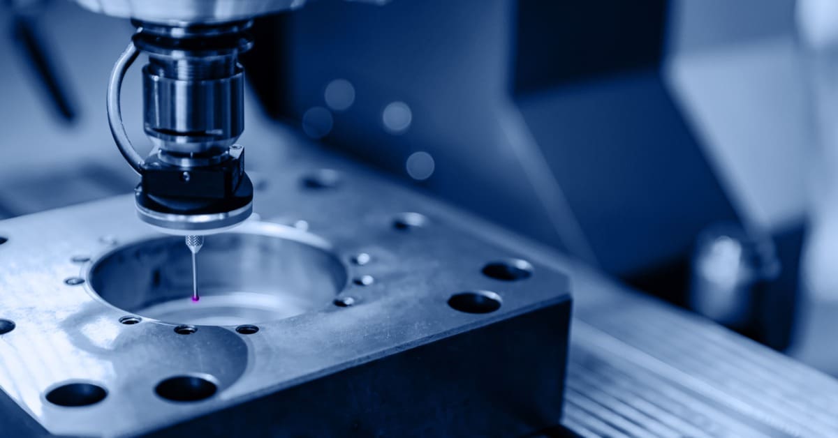 Close-up of coordinate measuring probe inspecting machined part, sensor tip contacting metal in industrial setup.