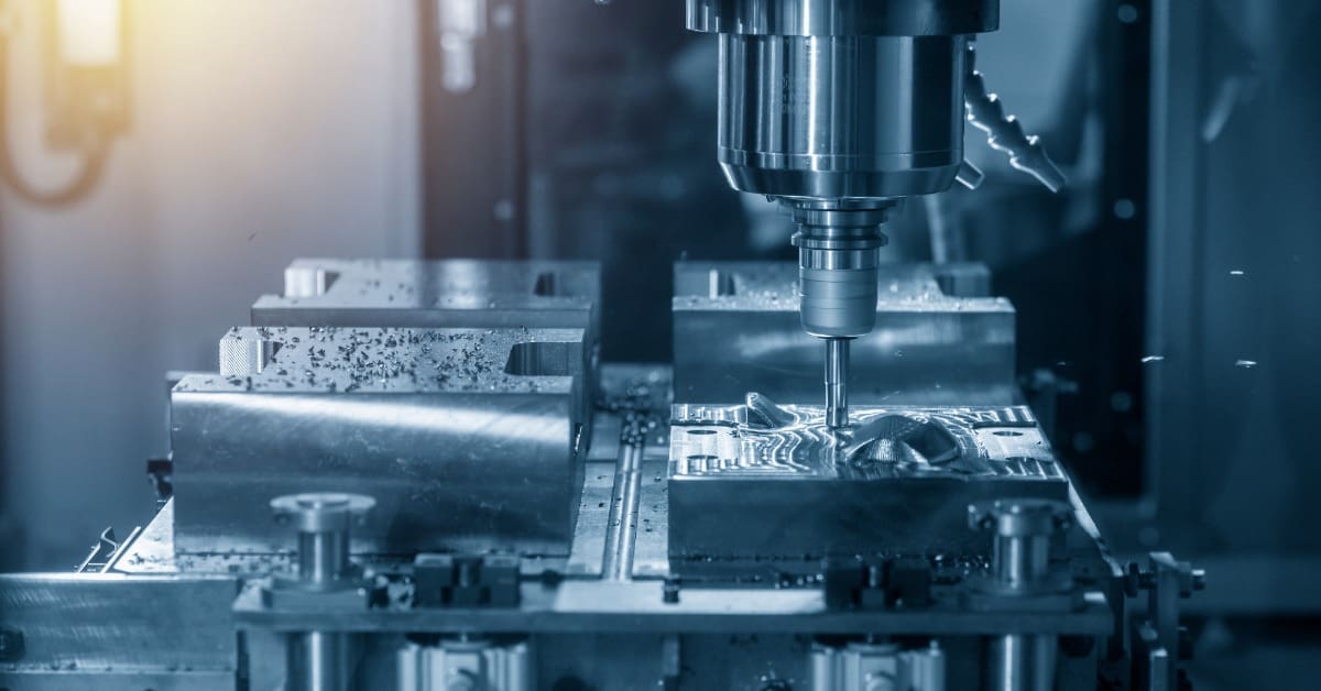 CNC milling machine cuts a precision metal component, with the spindle shaping the surface inside an enclosed workspace.